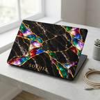 MacBook in a Jewel Tone black marble hard shell case with gold veins and colorful opal inlay, personalized with SOPHIA, on a white desk. Printed effect, smooth matte finish.