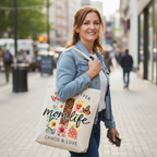 Smiling woman holding a personalized "Mom Life" tote bag, showcasing the vibrant boho western graphic.