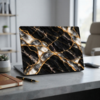 MacBook in a Black Pearl black marble effect hard shell case in an office with a pen and notebook.