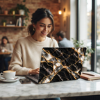 Woman in a café working at a marble table on a MacBook in a Black Pearl black marble printed case.