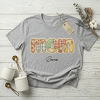 Model wearing a heather grey personalized "Mom" T-shirt, featuring the detailed minimalist patchwork floral art design for a casual yet stylish look.
