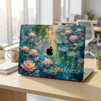 MacBook in a personalized water lilies hard shell case with the name Charlotte, open in a bright café workspace.