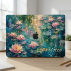 MacBook in a water lilies hard shell case personalized with the name Charlotte, Apple logo left visible, on a light desk. Printed design, smooth matte finish.