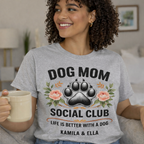 Personalized Sport Grey Dog Mom Social Club Shirt on Model, Custom Pet Names Kamila & Ella T-shirt, Floral Paw Print Aesthetic, Relaxed Fit Grey Tee for Dog Lovers, High-Quality Direct-to-Garment Print, TrioAuraDesign.