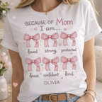 personalized mom t-shirt with bows design, because of my mom i am strong loved quote, custom name Olivia, white Gildan 5000 shirt