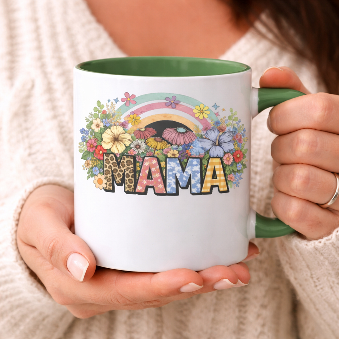 Woman holding a custom MAMA ceramic mug with a vibrant boho wildflower and rainbow graphic, perfect for a cozy morning

