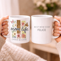 Double-sided personalized MAMA mug mockup showing the "Mom Life: Chaos & Love" leopard floral design on one side and the custom name Felice on the other, held by a woman.