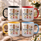 Collection of custom Boho Mom Life mugs with colored handles and rims (Black, Red, Yellow, Light Blue), showcasing the "Chaos & Love" wildflower leopard print, displayed on a wooden surface with a flower background