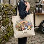 Woman carrying a personalized floral rainbow MAMA tote bag mockup on her shoulder in an outdoor setting with a coffee cart background