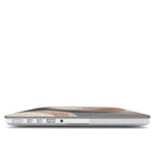 Side view of a MacBook featuring a personalized soft neutral abstract case with the monogram O.H., showcasing the slim-fit design and precision cutouts for all ports and connectors.