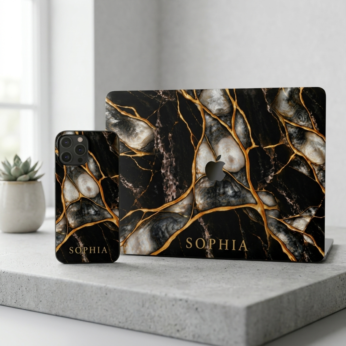 Matching set: Black Pearl marble iPhone case and MacBook case personalized with SOPHIA on a concrete surface.