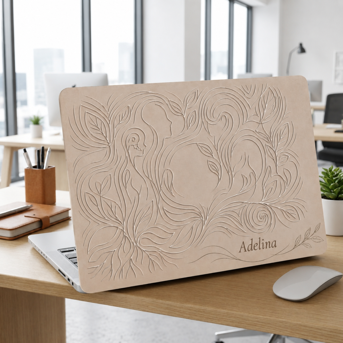 Open MacBook with a beige botanical hard shell case personalized with the name Adelina, full cover style, on an office desk. Printed design, smooth matte finish.