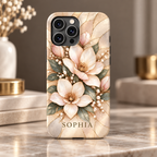 Champagne Bloom magnolia iPhone case personalized with SOPHIA lying on a marble surface.