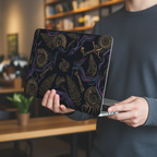 Lifestyle photo of a person carrying a MacBook with two hands. The glossy hard shell case features a paleo-futuristic 3D design of golden fossil ammonites, ferns, and bones accented by glowing neon purple and cyan cyber-lines.