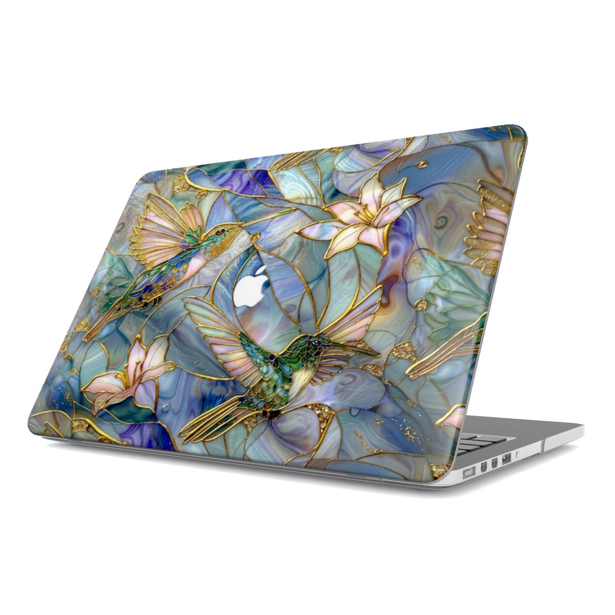 Isolated angled view of a MacBook with a protective hard shell case against a white background. The case features an intricate stained glass mosaic design of emerald green hummingbirds and lilies with gold-accented outlines. A central cutout in the artistic pattern reveals the Apple logo on the silver laptop lid.