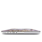 A focused side view of a MacBook wearing a custom purple lavender and circuit board case, showcasing precise cutouts for USB-C, MagSafe, and a headphone jack. The thin protective edges of the case are visible.