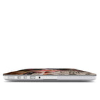 Side view of a MacBook with an "Art Will Save Us" collage hard case, showing precise cutouts for easy access to USB ports, charging slot, and headphone jack.