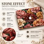 Stone Bouquet MacBook case infographic showing blush pink, burgundy, ivory and golden stone-effect flowers in close-up. Explains that the dimensional carved-stone appearance is created with high-definition printing and the actual case surface is smooth, with no real stone, raised texture or sculpted elements.