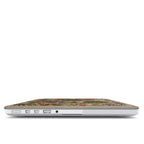 A focused side view of a MacBook with a Secret Garden wildflower embroidery-style case. It showcases accurate cutouts for MagSafe, USB-C, and headphone ports, highlighting the slim protective design.