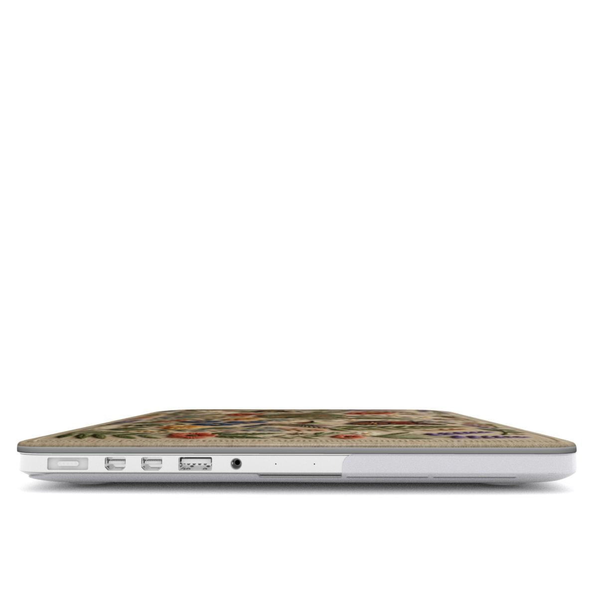 A focused side view of a MacBook with a Secret Garden wildflower embroidery-style case. It showcases accurate cutouts for MagSafe, USB-C, and headphone ports, highlighting the slim protective design.
