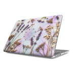 Silver MacBook featuring a high-definition custom case with dried lavender flowers and wildflowers integrated into a glowing purple and white digital circuit board design.board pattern.