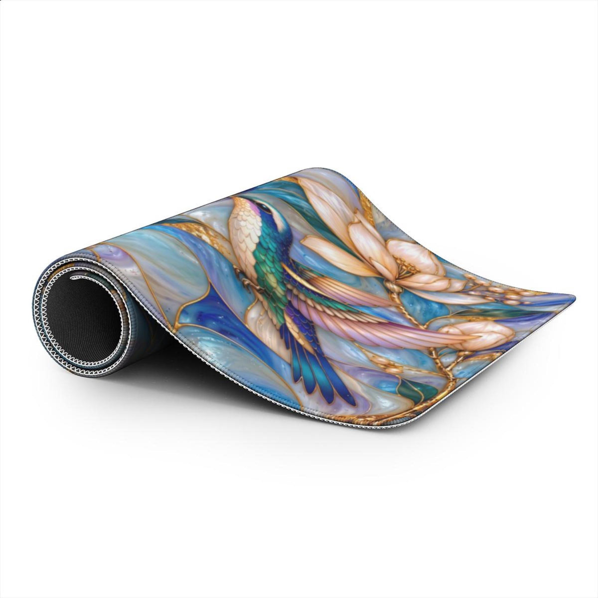Rolled hummingbird desk mat showing the black rubberized non-slip base and the soft printed top.