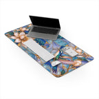 Hummingbird desk mat with laptop, keyboard and mouse on a white background, showing the calm center under the devices.