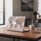 Vintage world map MacBook case on modern office desk with coffee cup and notebook, antique cartographic laptop cover in rose and sage tones