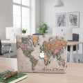 Personalized vintage world map MacBook case with custom name Alex Chen in handwritten script, lifestyle photo in modern office workspace