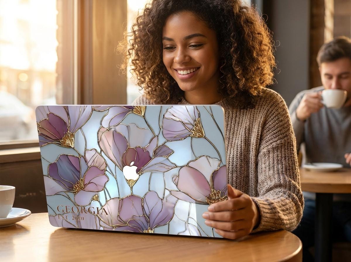 Woman smiling in cafe with custom name stained glass floral MacBook case, personalized purple gold magnolia hard shell laptop cover gift for her