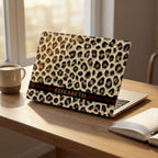 Custom leopard print MacBook case with personalized name, cheetah pattern hard shell laptop cover, warm home desk setup with mug and notebook