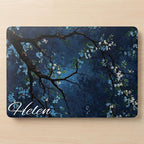 Custom name MacBook case with dark navy botanical floral design, personalized with white script name Helen, flat lay top view on wooden surface showing full print