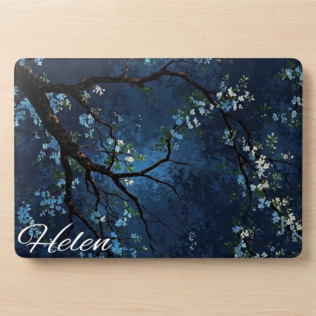 Custom name MacBook case with dark navy botanical floral design, personalized with white script name Helen, flat lay top view on wooden surface showing full print