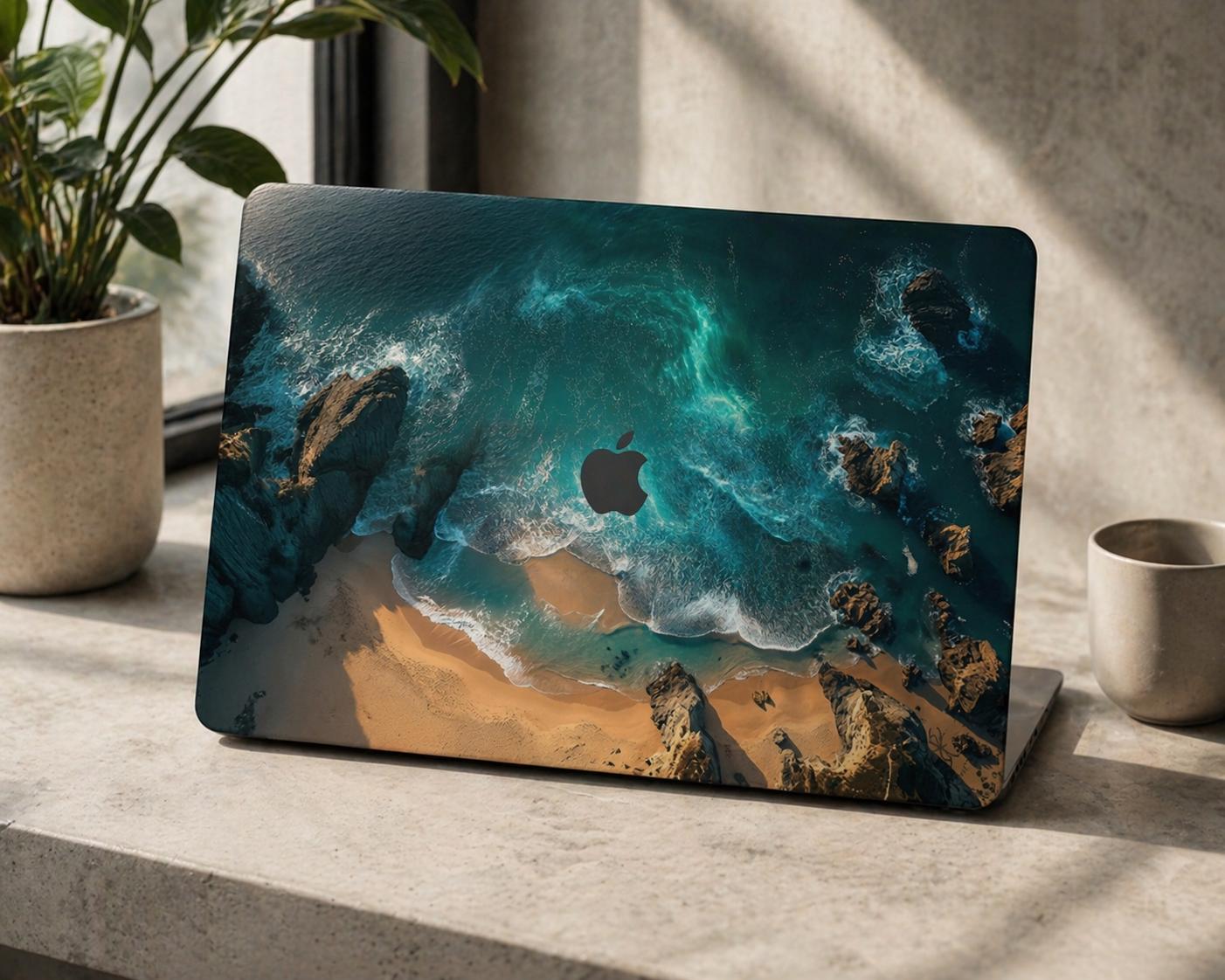 Ocean aerial view MacBook hard shell case on concrete surface with plant, turquoise sea and rocky coastline aesthetic laptop cover