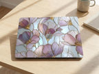 Stained glass floral MacBook case top view on wooden desk with coffee cup, purple pink gold magnolia hard shell laptop cover elegant aesthetic