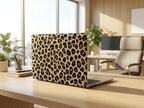 Leopard print MacBook case on desk in modern bright office, full cover cheetah pattern hard shell laptop cover, professional workspace setup