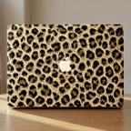 Leopard print MacBook hard shell case close-up, full cover cheetah pattern, warm natural light product shot