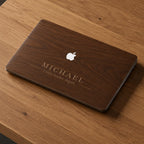 Personalized wood grain MacBook case with custom name Michael and phrase "Create. Inspire. Impact." in elegant serif font. Rich warm walnut wood texture displayed flat on wooden surface, close-up product shot showing engraved style personalization. Hard shell cover for MacBook Air 13 M3 M4, MacBook Air 15, MacBook Pro 14 M5 2026, MacBook Pro 16. Perfect personalized birthday gift, graduation gift or Father's Day gift for him, husband or boyfriend.