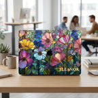 Colorful Garden MacBook case personalized with Eleanor on a desk in a bright open-plan office.