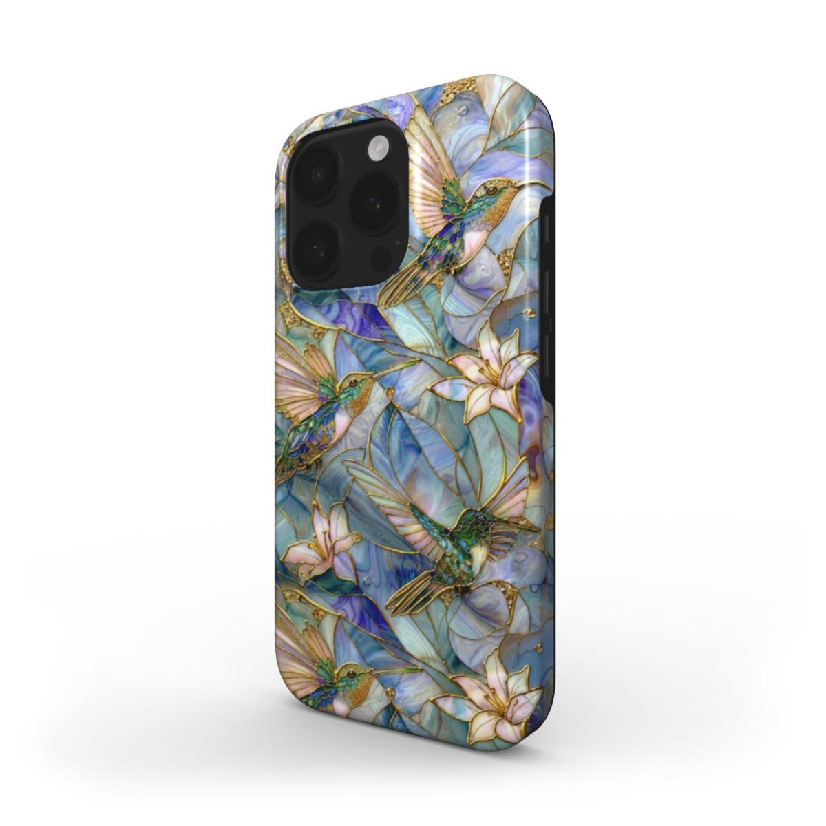 Angled view of a stained glass effect iPhone case featuring colorful hummingbirds, white lilies, and botanical artwork in rich blue, teal, ivory, and gold tones. The glossy protective case showcases smooth edge-to-edge UV printing inspired by classic stained glass windows while revealing the slim profile, rounded edges, and side button design. Displayed on a clean white background. Available from TrioAuraDesign.