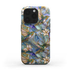 Front view of a stained glass effect iPhone case featuring colorful hummingbirds, white lilies, and botanical artwork inspired by classic stained glass windows. The glossy protective case showcases rich blue, teal, ivory, and gold tones with smooth edge-to-edge UV printing that creates the appearance of stained glass. Displayed on a clean white background to highlight the detailed artwork and premium finish. Available from TrioAuraDesign.