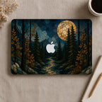 Personalized stained glass effect MacBook hard shell case shown from above, featuring a dark evergreen forest, golden autumn leaves, blue mountains, winding path and glowing full moon, with the Apple logo visible in the center. Custom fall laptop cover for MacBook Air 13 15, MacBook Pro 13 14 16 and MacBook Neo. Nature-inspired personalized case by TrioAuraDesign.