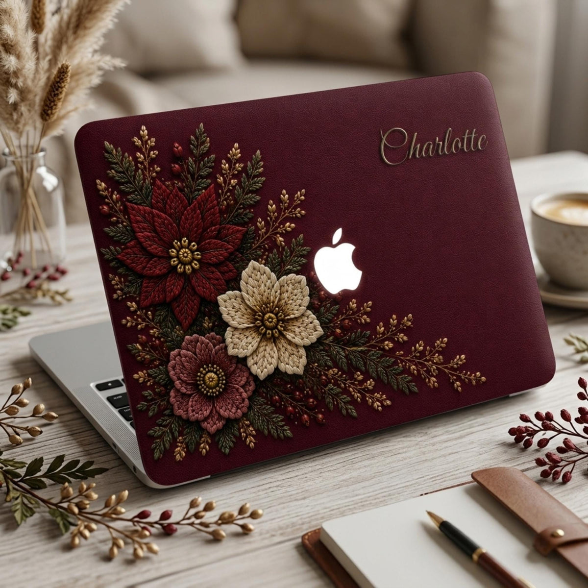 Personalized deep wine Crochet effect floral MacBook case from TrioAuraDesign, featuring rich burgundy, ivory and dusty rose flowers with dark botanical greenery, red berries and gold-toned details. Custom name “Charlotte” appears in elegant gold script at the upper right, with the Apple logo visible at center. Smooth printed hard shell laptop cover with a luxurious dark floral look, available in my shop for MacBook Air, Pro and Neo models.