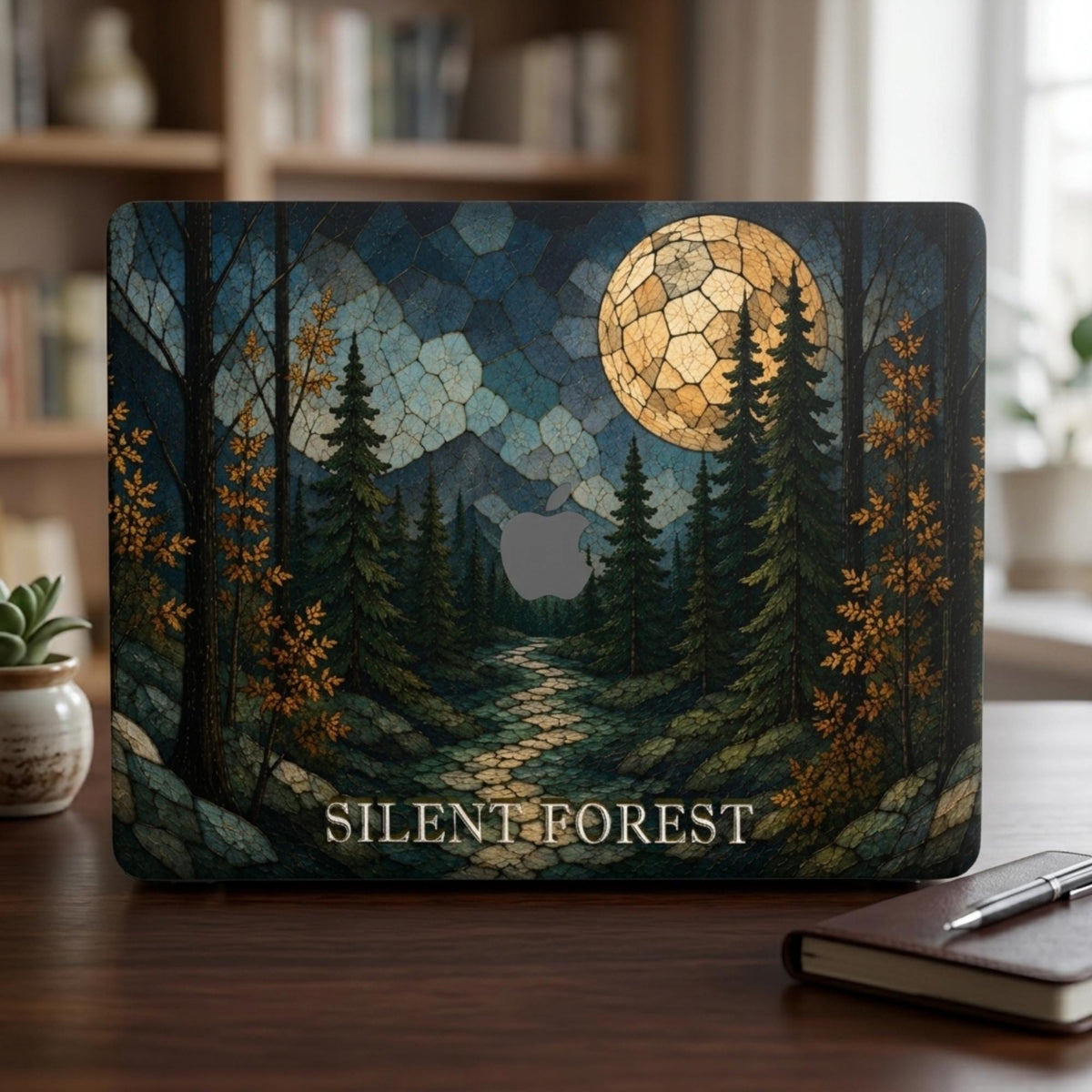 Personalized stained glass effect MacBook hard shell case featuring a dark evergreen forest, golden autumn leaves, blue mountains, winding path and large glowing full moon. “SILENT FOREST” is printed in light serif lettering across the bottom, with the Apple logo area visible in the center. Custom fall laptop cover for MacBook Air 13 15, MacBook Pro 13 14 16 and MacBook Neo. Nature-inspired case by TrioAuraDesign.