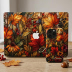 Matching personalized autumn stained glass effect MacBook and iPhone cases from TrioAuraDesign, displayed together in a warm seasonal setting with maple leaves, berries and an acorn. Both smooth printed cases feature rich orange, red, gold and olive botanical artwork with a stained glass mosaic look, plus custom name personalization. Coordinating fall tech covers for compatible MacBook and iPhone models.