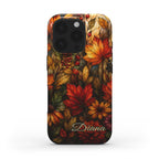 Personalized autumn stained glass effect iPhone case from TrioAuraDesign, shown as a clean product mockup on a white background. The smooth printed case features layered maple leaves, berries and florals in burnt orange, deep red, golden yellow and olive tones, creating a rich stained glass mosaic look. Custom name “Diana” appears near the bottom for a personalized finish.