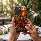 Personalized autumn stained glass effect iPhone case from TrioAuraDesign, featuring a rich mosaic of glowing maple leaves, berries, florals and layered botanical details in burnt orange, deep red, golden yellow, olive and warm brown tones. Custom name “Diana” appears near the bottom. Artistic fall phone case with a smooth printed finish, inspired by luminous stained glass and autumn foliage, available in my shop.