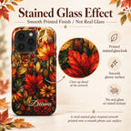 Stained glass effect iPhone case infographic from TrioAuraDesign, showing the personalized autumn botanical design with vivid maple leaves, berries and florals in red, orange, gold and olive tones. Close-up details explain that the stained glass look is created through high-definition printing on a smooth glossy surface, with no real glass or raised texture. Personalized phone case available in my shop.