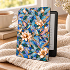 Hummingbird stained glass effect Kindle Paperwhite case on a cozy blanket with tea, Art Nouveau magnolia and hummingbird cover
