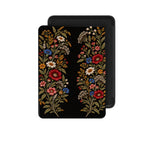 Front view of the Black Wildflower Kindle Paperwhite case: two garlands of burgundy, blue, ivory and gold wildflowers on a black cover